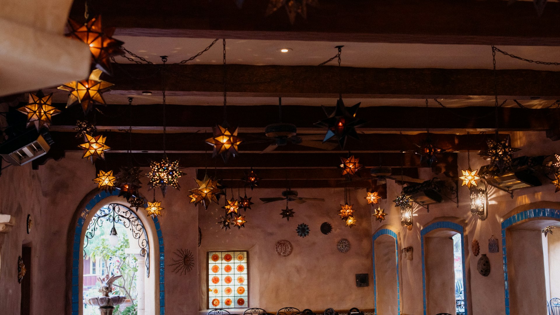 a church with a stained glass window and star decorations hanging from the ceiling